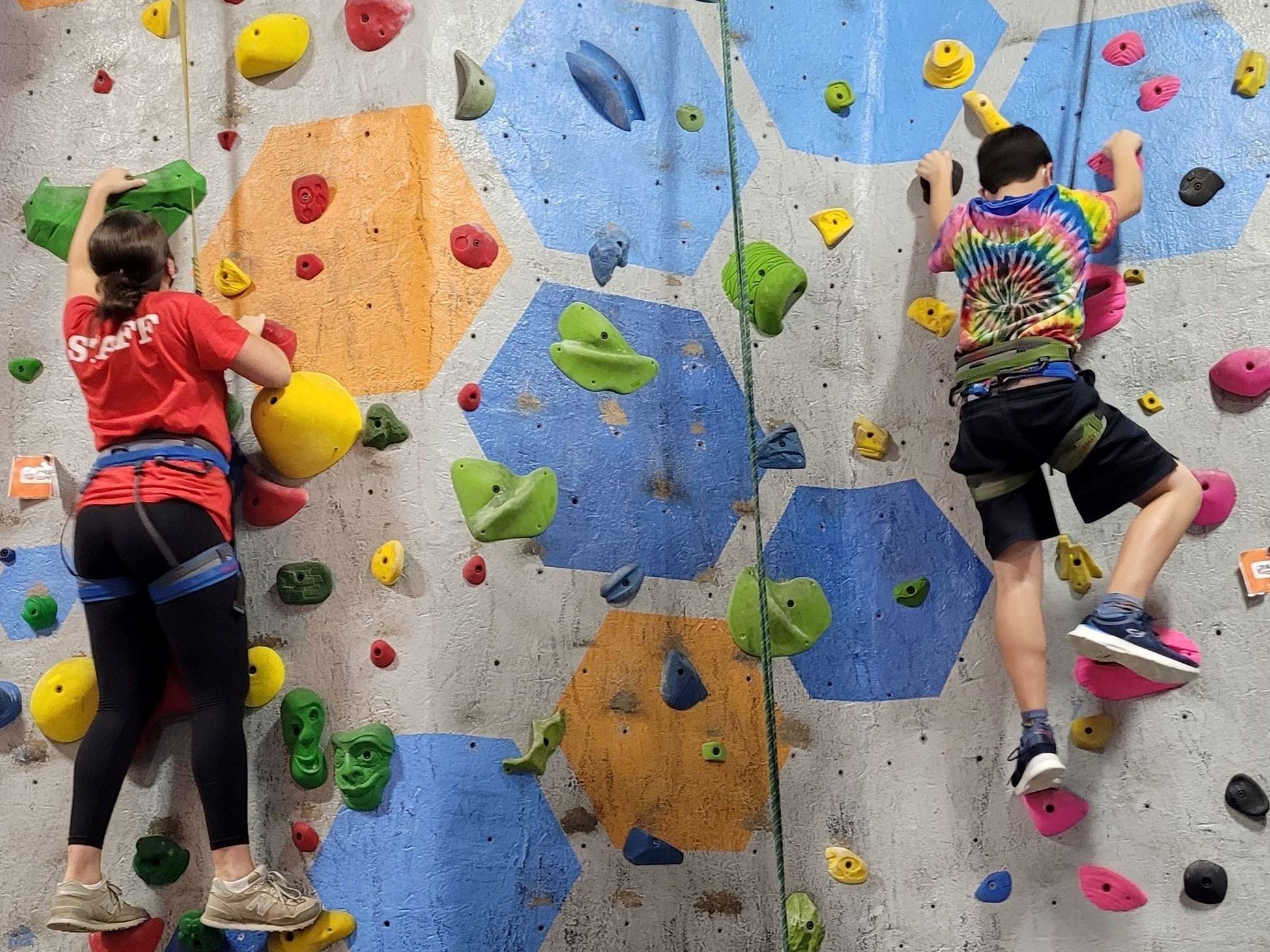 Staff and participant indoor rock climbing at Rockspot